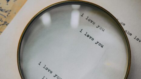 Photo by KoolShooters Close-up of a magnifying glass highlighting 'I love you' on a letter, capturing romantic sentiment.